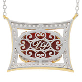 Elegant oval red coral pendant in sterling silver, featuring intricate design and sparkling gemstones, perfect for sophisticated style.